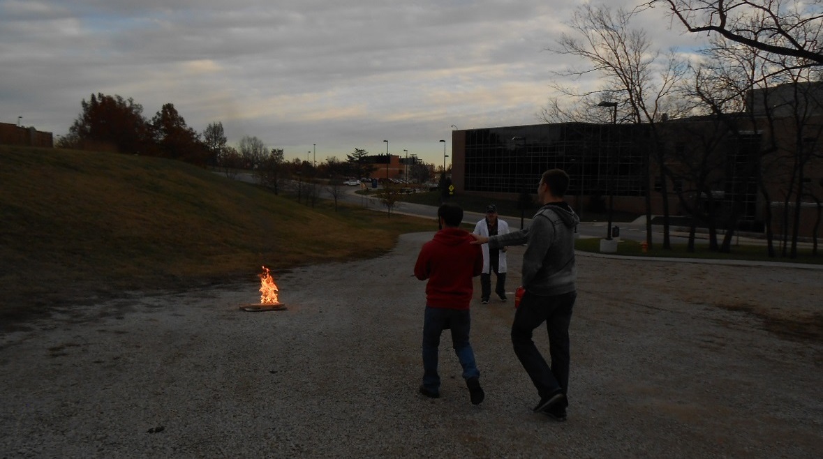 Image of Students using a fire extinguisher